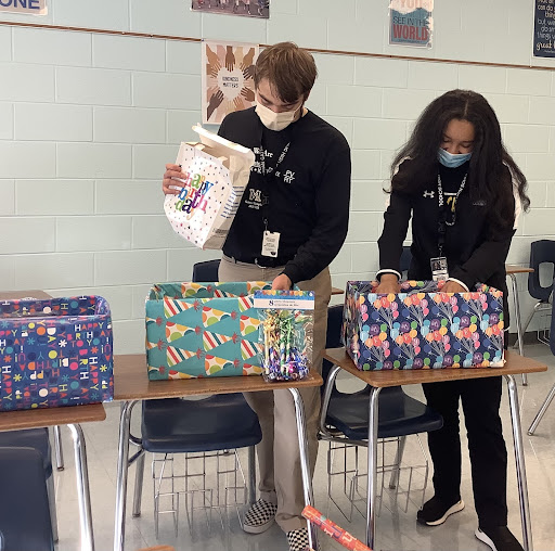 Service Club members collect materials to be donated to students and seniors in need.